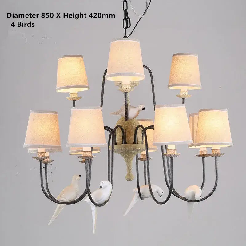 Rustic wood and iron decorbites bird lamp chandelier with dark metal frame, white bird figurines, and warm fabric shades