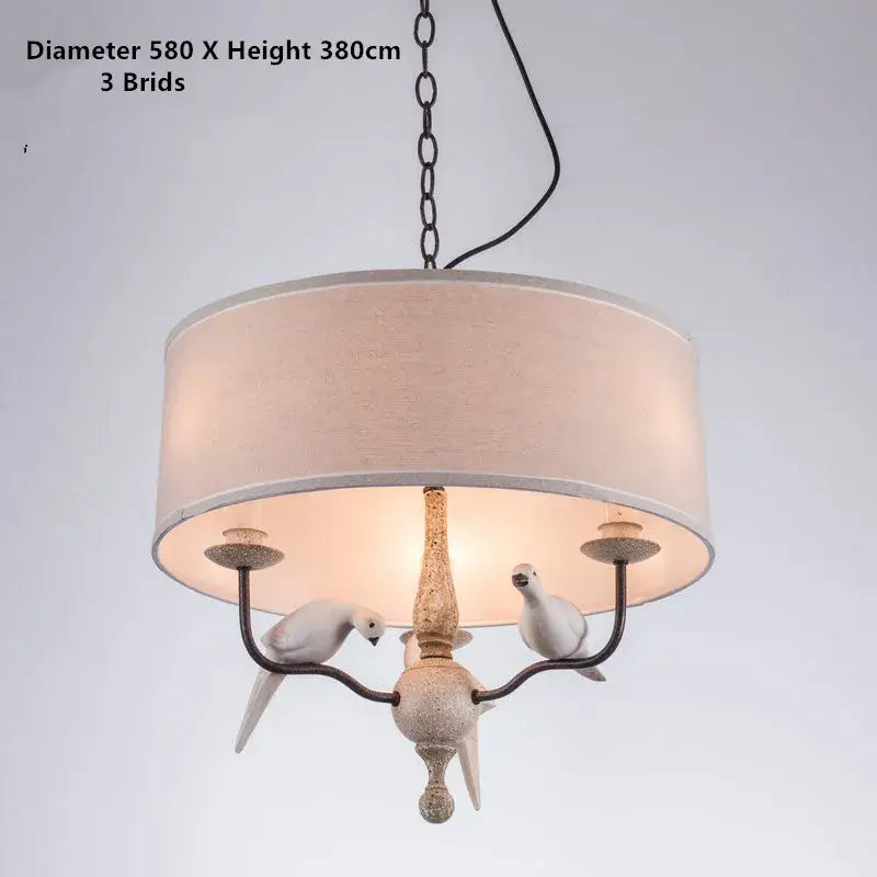 Rustic wood and iron decorbites bird lamp chandelier with beige linen shade and white bird figurines for dining room