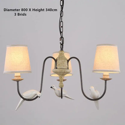 Antique bronze decorbites bird lamp chandelier with three white ceramic doves and cream fabric shades for dining room