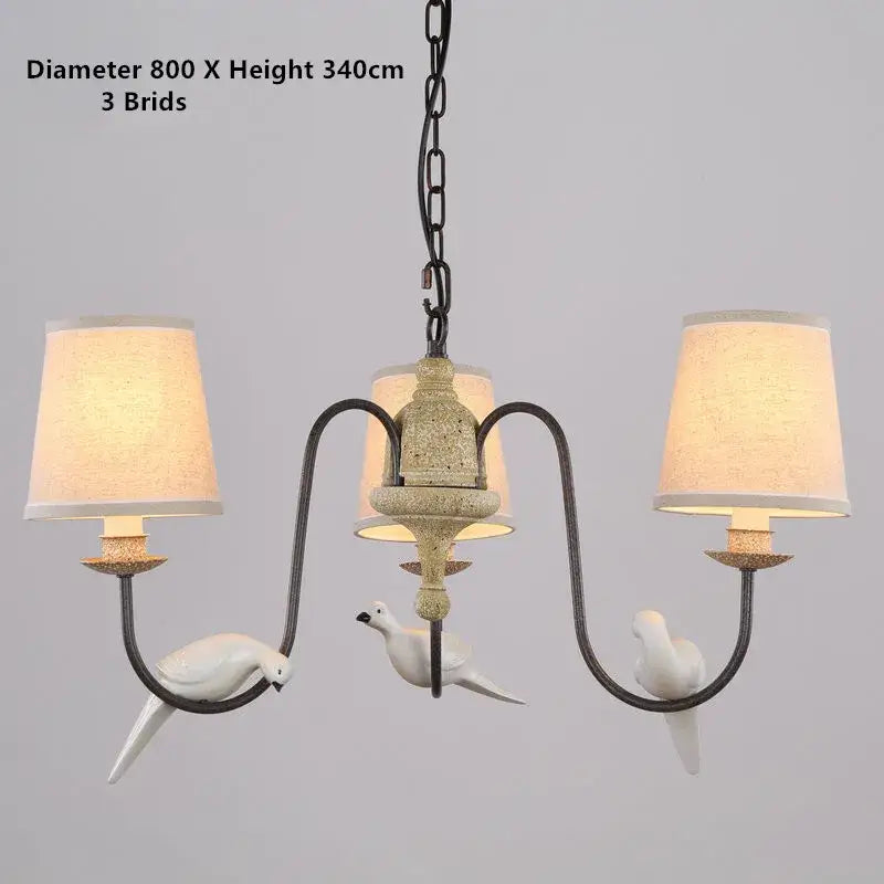 Antique bronze decorbites bird lamp chandelier with three white ceramic doves and cream fabric shades for dining room