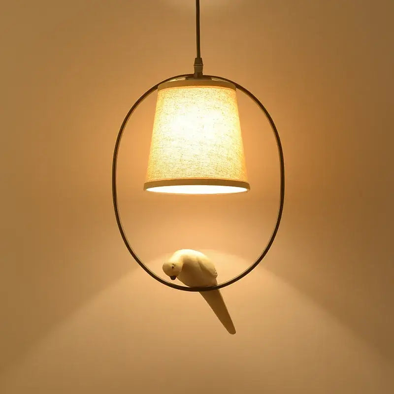 Rustic wood and iron decorbites bird lamp with beige fabric shade and white ceramic parrot for dining room lighting