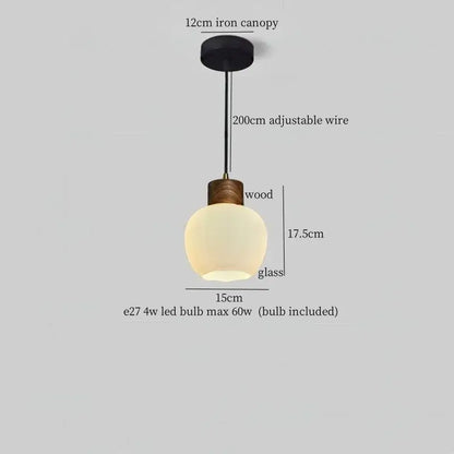 Rustic wood and ribbed glass led pendant light with matte black iron canopy and adjustable wire perfect for dining room lighting