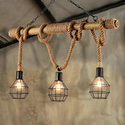 Rustic industrial island light with wooden beam wrapped in rope and three black caged edison bulbs for dining room