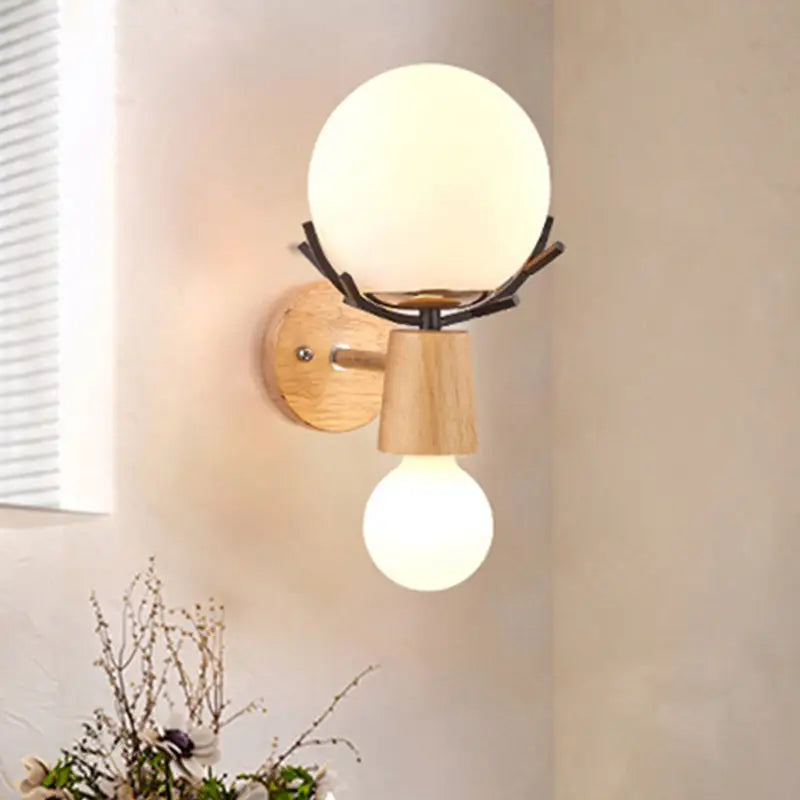 Rustic wood and white globe sconce wall lamp with frosted glass shade and antler-like metal arms for stairways