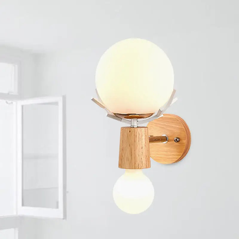 Modern wall lamp with white globe sconce featuring frosted glass globe, wooden base, and metallic accents for stairways