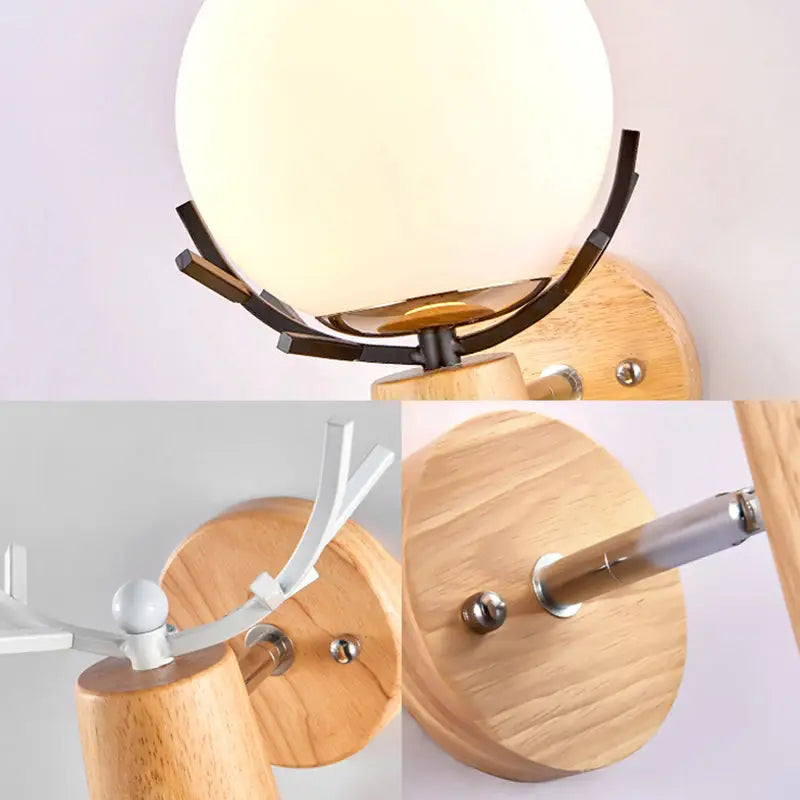 Rustic wood and white globe sconce wall lamp with warm-toned spherical glass and dark metal antler frame for stairways