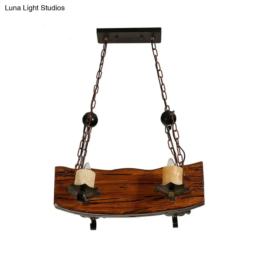 Rustic wooden two-light pendant lamp with black spherical accents and dark metal chains for wood board island use