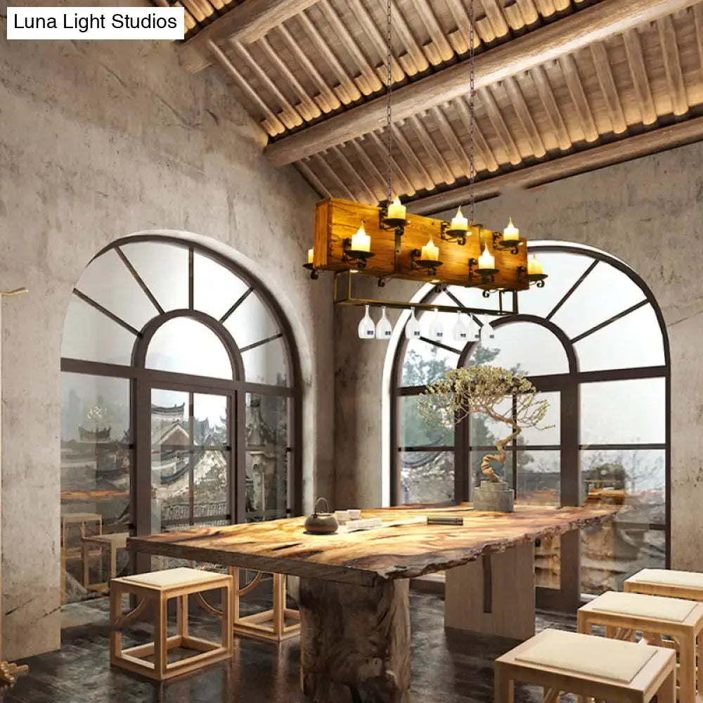 Rustic brown wood candelabra pendant light with candle-style lights and hanging wine glasses for dining room decor