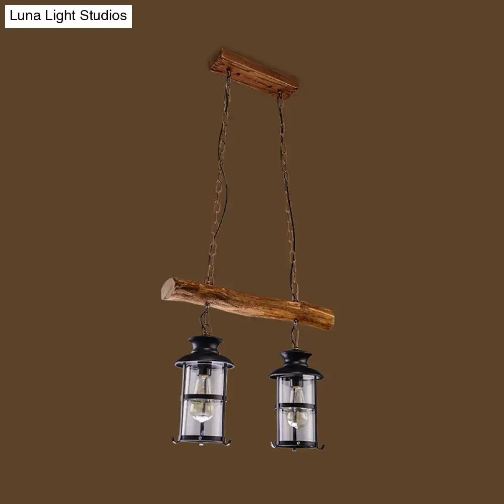 Rustic wooden beam pendant light with two black lanterns and metal chains featuring wood design and clear glass accents