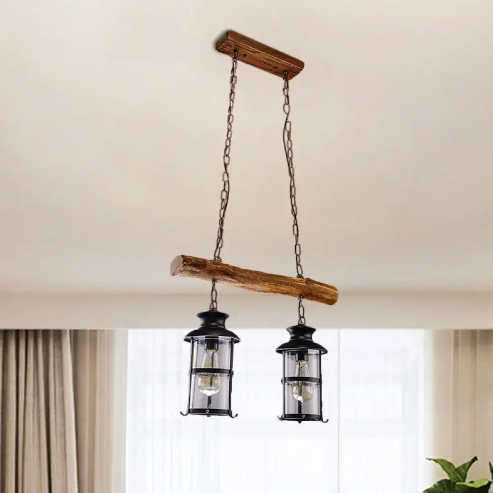 Rustic wooden beam pendant light with two black lantern-style fixtures featuring clear glass and wood design in brown
