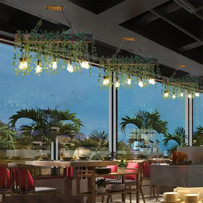 Rustic wood hanging chandeliers with green vines and edison bulbs designed as bar hanging chandeliers for dining rooms