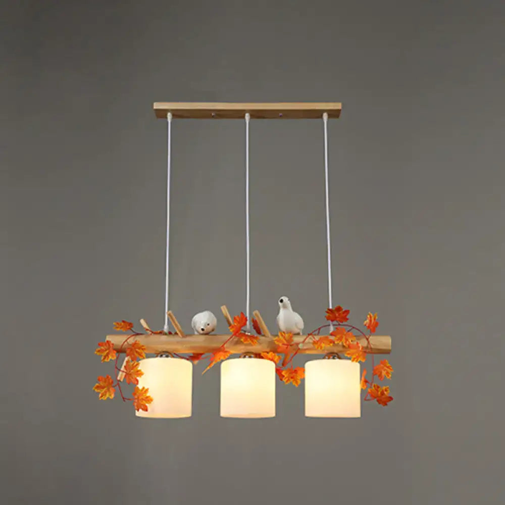 Decorbites modern wood linear island lighting with warm-toned shades, natural wood frame, and maple leaf plant accents