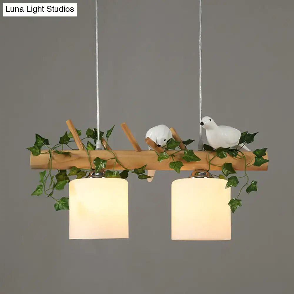 DecorBites natural wood linear island light with white ceramic birds and green ivy leaf plant accents for restaurants