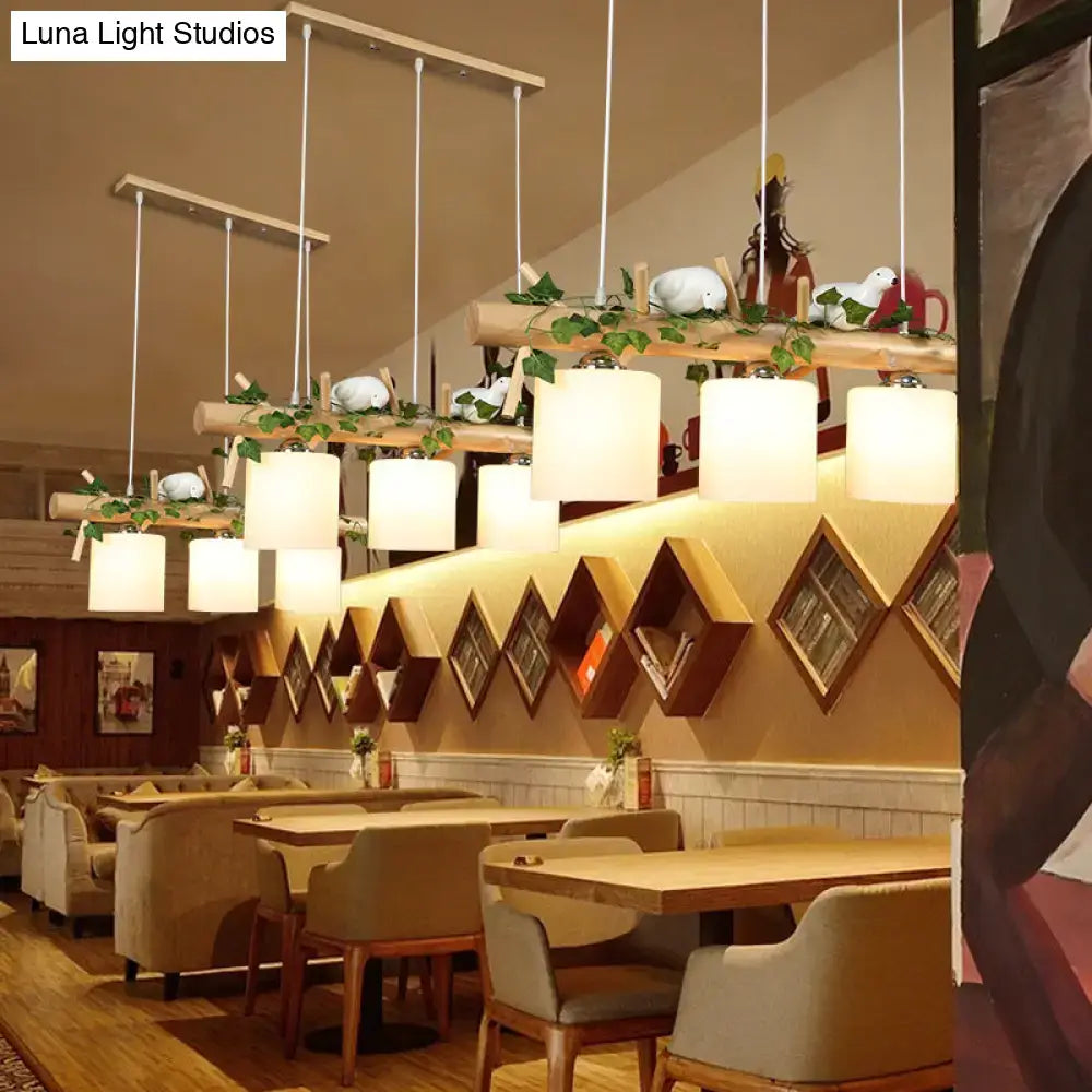 Warm-toned cylindrical maple leaf plant pendant lights hang from natural wood beams in decorbites modern wood island lighting