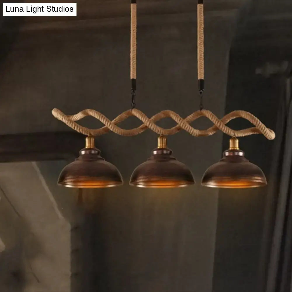 Three-bulb pendant light with rustic wooden beam beige twisted rope and warm brass accents for kitchen island lighting