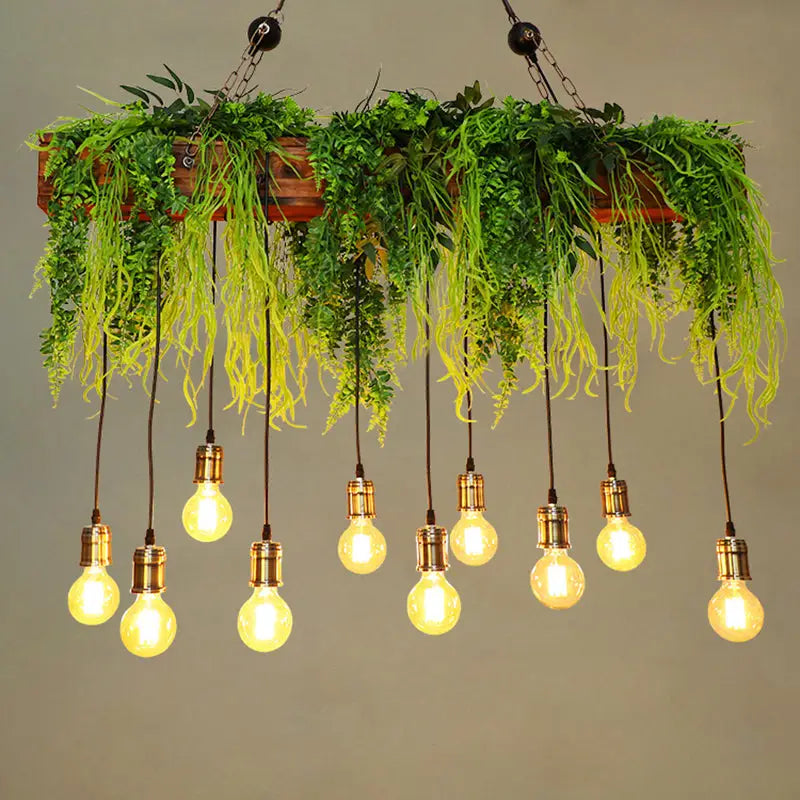 A rustic wooden planter with cascading green fern deco and hanging e26 e27 edison bulbs with bare bulb fixture width