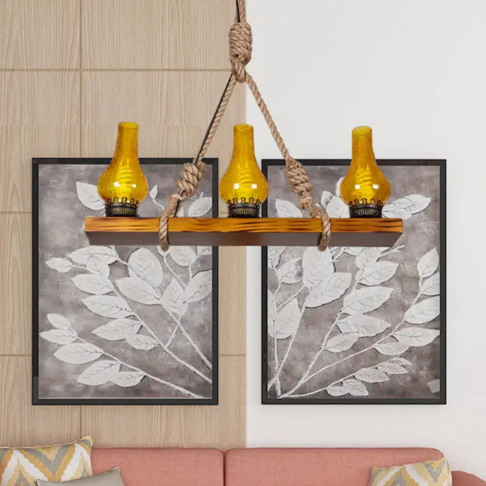 Rustic wooden linear island shelf with three amber glass lanterns and yellow cracked glass shades for living room
