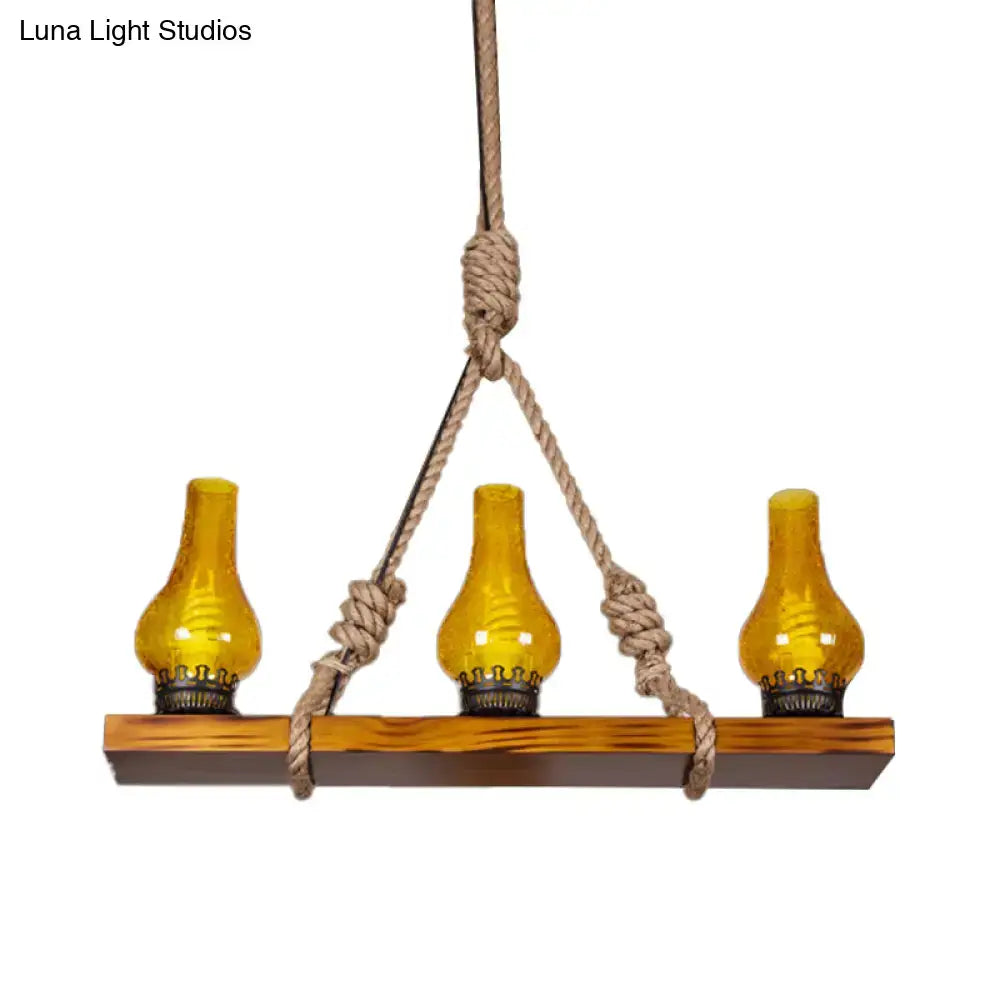 Rustic hanging decorbites pendant light with three yellow cracked glass oil lamps on wooden linear island beam for living room