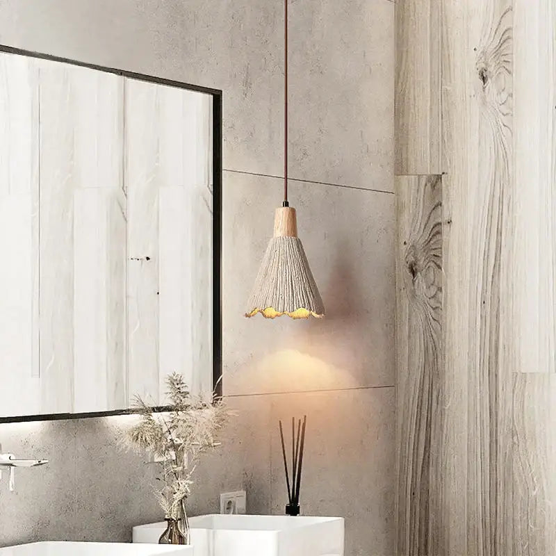A warm-toned decorbites designer pendant with a woven grayish brown shade and natural wood top from pendant lamps collection