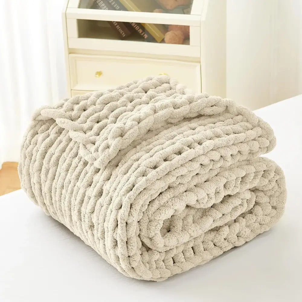 A cream-colored chunky knit fleece blanket with a plush texture perfect for decorbites cozy autumn fleece decor