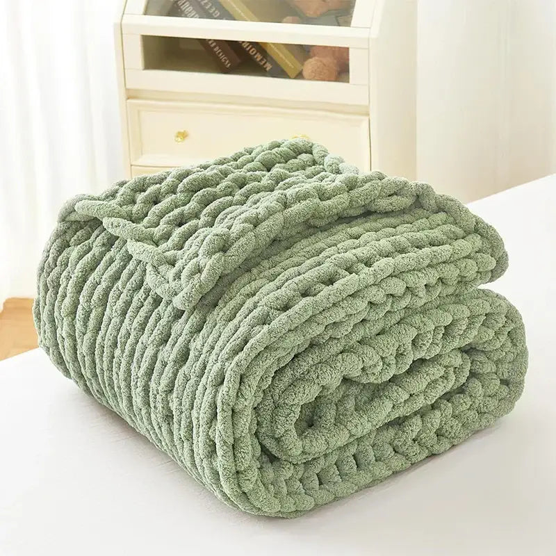 A sage green chunky knit fleece blanket with a textured braided pattern from decorbites cozy autumn fleece collection