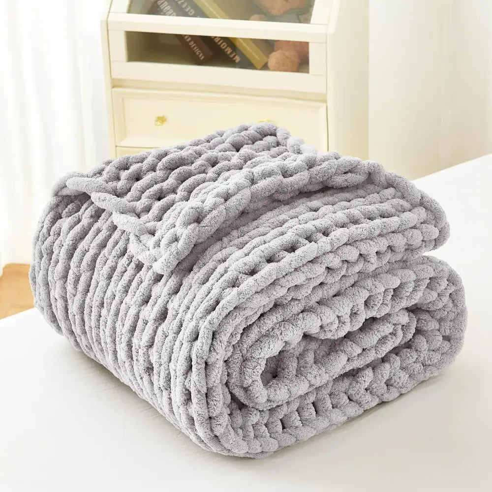 A sage green chunky knit cozy autumn fleece blanket with a soft braided texture perfect for decorbites cozy autumn use