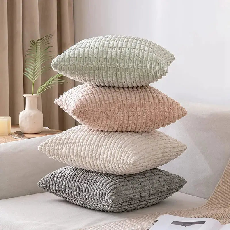 Stack of four textured corduroy velvet throw pillows in soft pastel shades including sage green corduroy pillowcase set