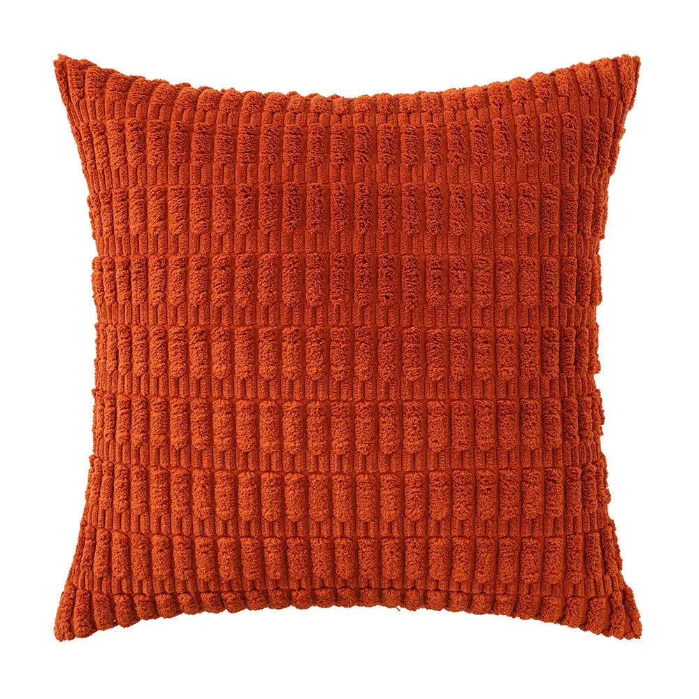 A rust-orange corduroy velvet throw pillow with vertical ribbed texture from a sage green corduroy pillowcase set