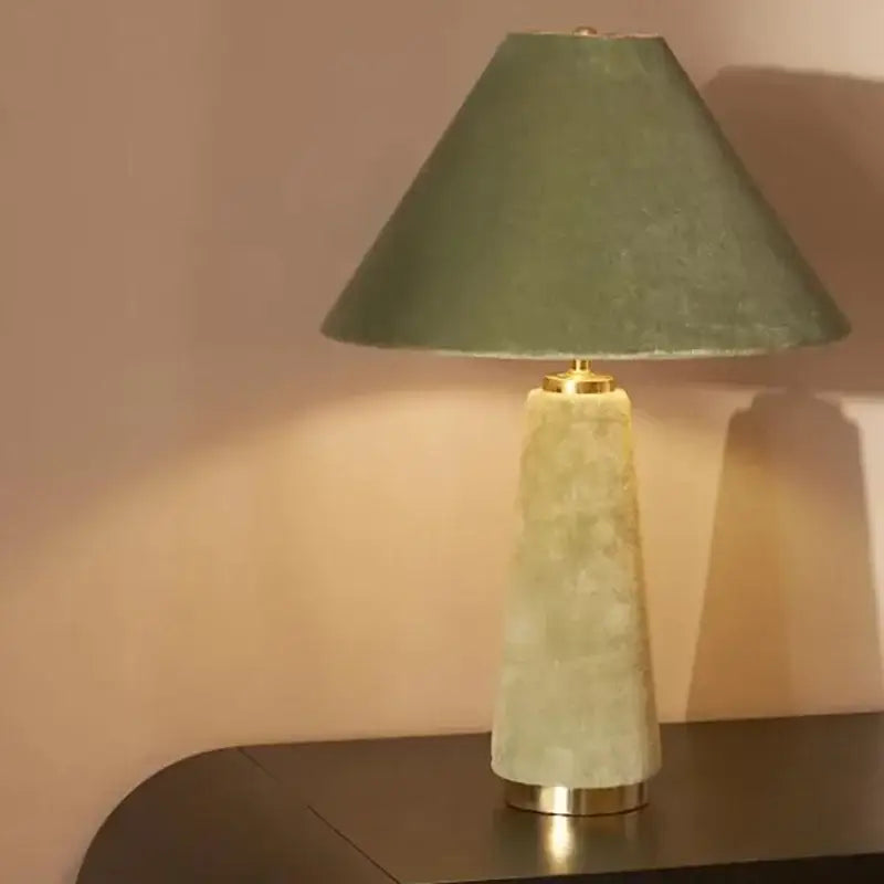 A sleek sage green cotton velvet floor lamp with a textured fabric shade and light-green stone base decorbites cotton velvet