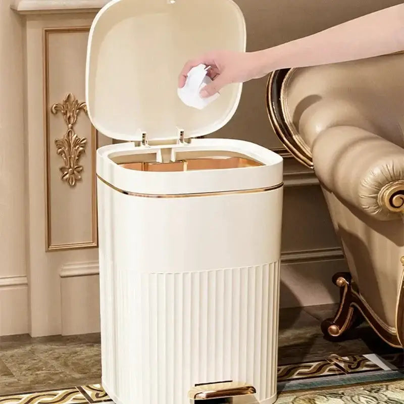 Cream-colored rectangular pedal trash can with ribbed texture and gold-tone accents from decorbites light luxury collection