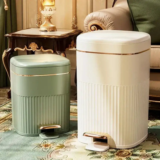 Two elegant sage green and cream ribbed pedal trash cans with gold-tone accents from decorbites light luxury pedal series