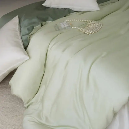 A delicate pearl-embellished handbag rests elegantly on a sage green double layer satin queen duvet set