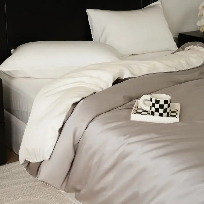 A taupe soft satin duvet set with subtle sheen and white pillowcases in a sage green double layer satin queen design