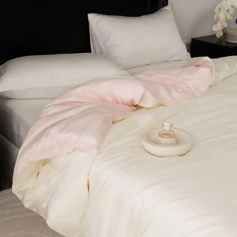 Soft pink and cream satin duvet set with subtle sheen draped over white bedding from sage green double layer satin queen collection