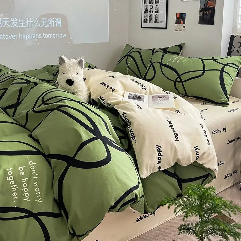 Sage green grid print cotton bedding set with green and cream fabric featuring black abstract lines and motivational phrases