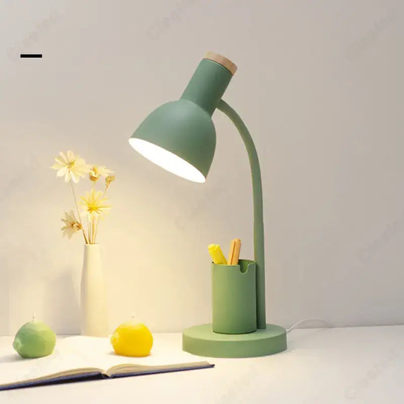 A sleek matte sage green nordic desk lamp with curved neck wooden top accent and pen holder by decorbites cute nordic