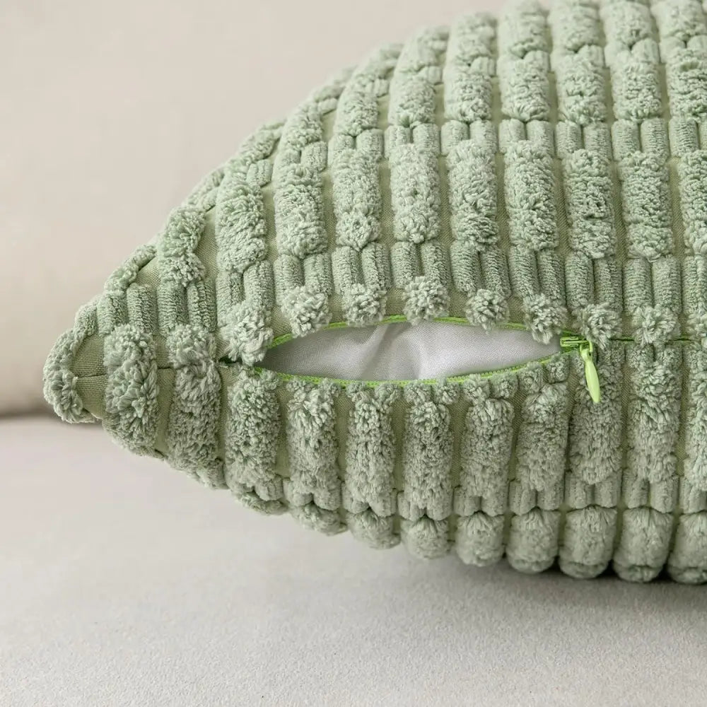Sage green ribbed corduroy throw pillow cover with plush texture and visible zipper closure for living room decor