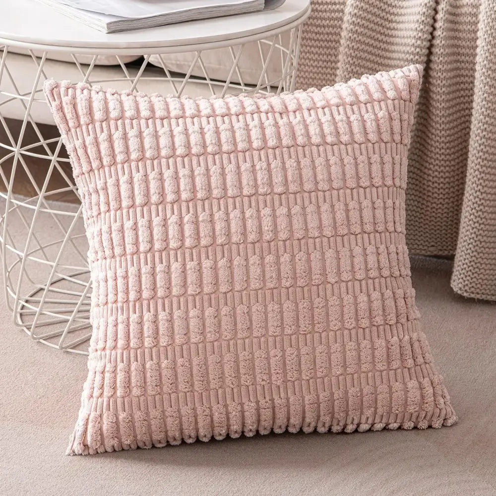 A soft blush pink textured throw pillow cover with a raised woven pattern for living room decor