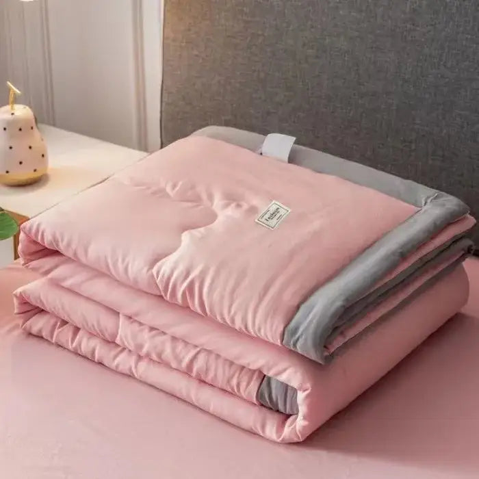 Pink and gray quilted blanket with soft plush texture in decorbites cooling cotton quilt for bedroom use