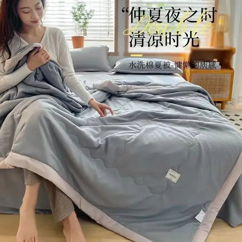 A soft light gray cooling cotton quilt with pale pink trim for summer decorbites cooling cotton bedroom use