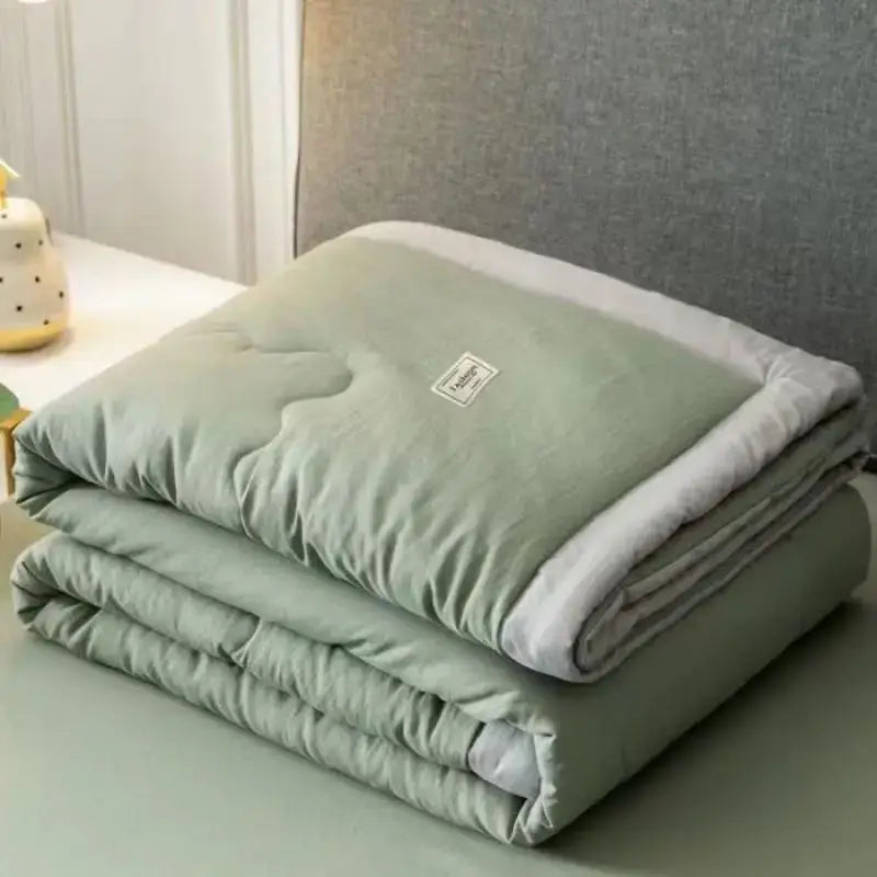Sage green and white cooling cotton quilt bedroom blanket with plush lining and subtle stitching from decorbites cooling cotton
