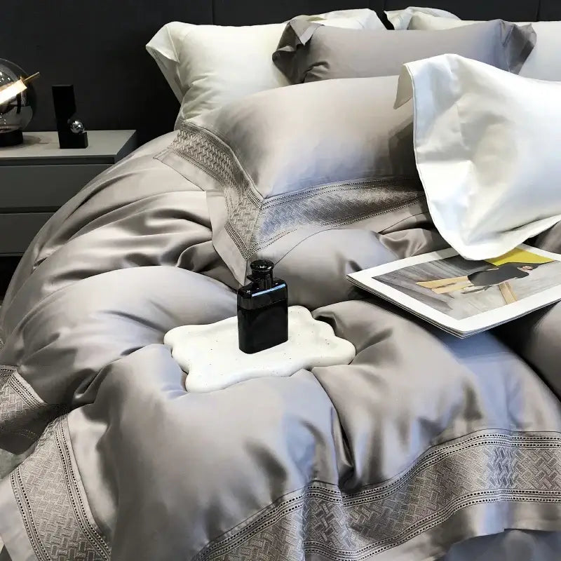 A sleek black perfume bottle on a white cloud-shaped tray highlighting decorbites 1000tc lyocell fibre bedding set decor