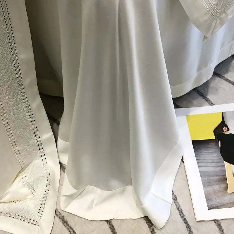 A flowing white satin curtain with subtle sheen and delicate embroidered trim from decorbites 1000tc lyocell fibre bedding set