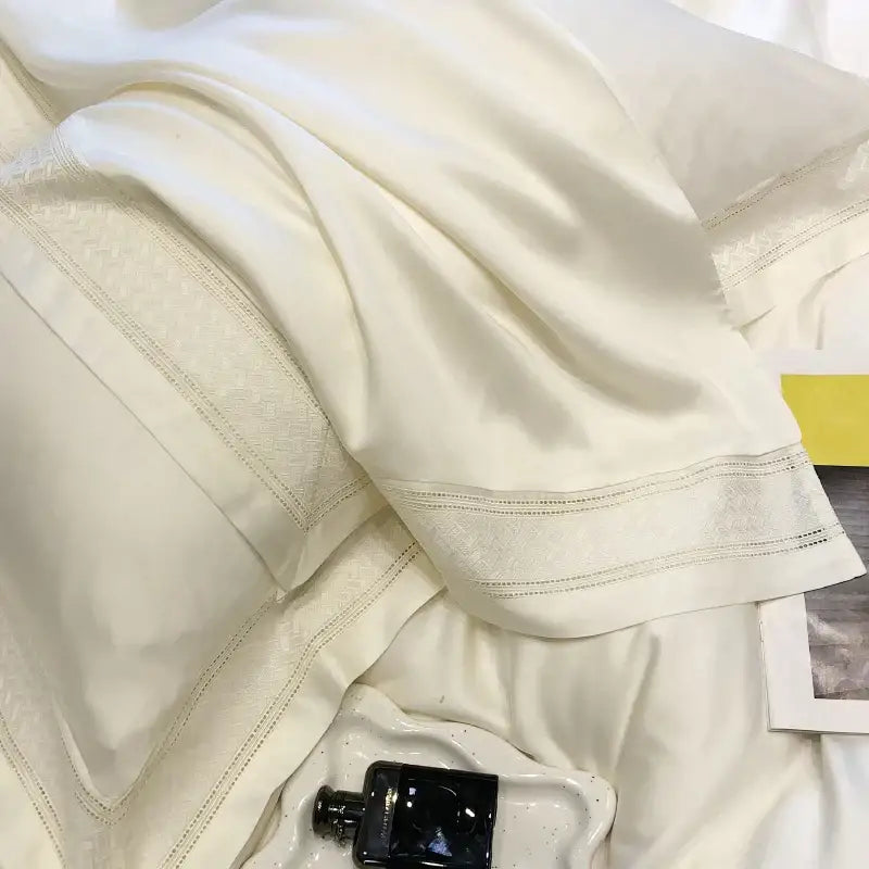 Cream-colored satin pillowcase with delicate embroidered trim and subtle sheen from decorbites 1000tc lyocell fibre bedding set