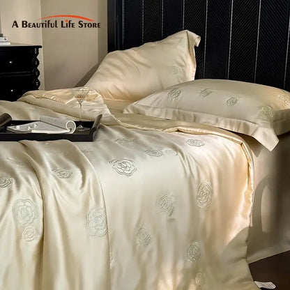Cream-colored satin quilt set with delicate silver eucalyptus fiber flower embroidery for elegant bedroom decorbites
