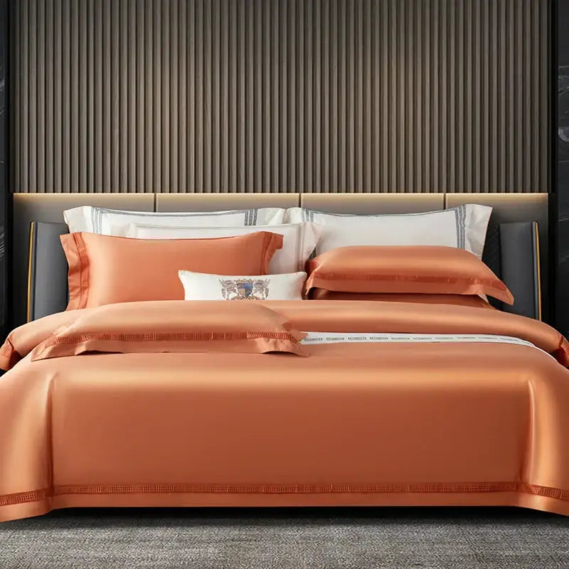 Orchid-colored satin duvet cover set with embroidered detailing and subtle striped border in cream and gold egyptian cotton