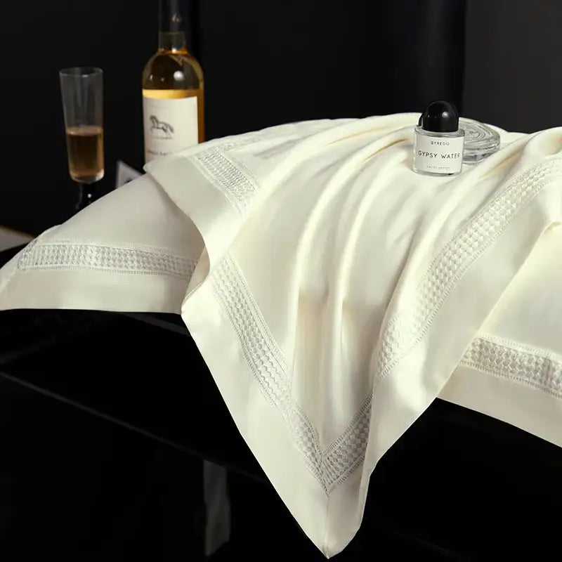 Cream-colored silk pillowcase with silver-threaded embroidery in satin cream and gold egyptian cotton duvet cover set
