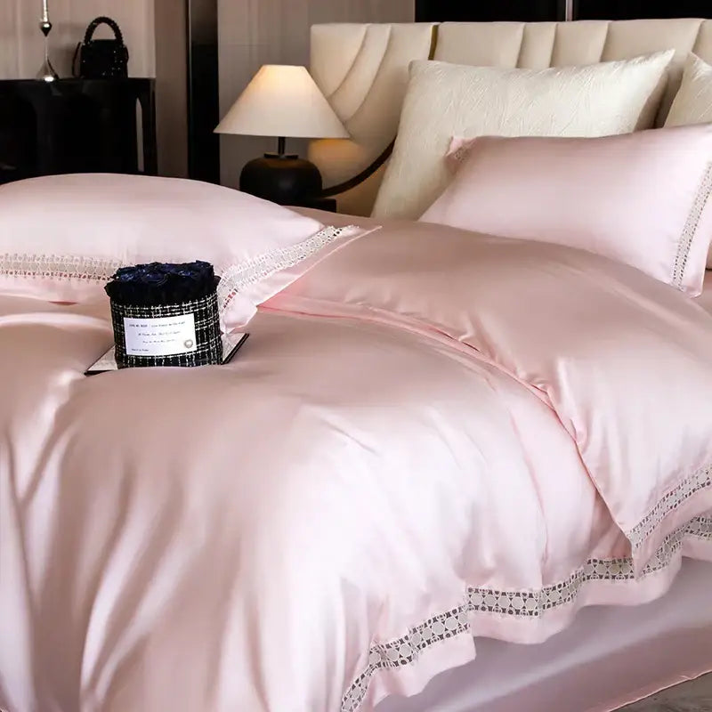 Pink satin duvet cover with delicate black lace trim as part of a satin cream and gold lace eucalyptus duvet cover set