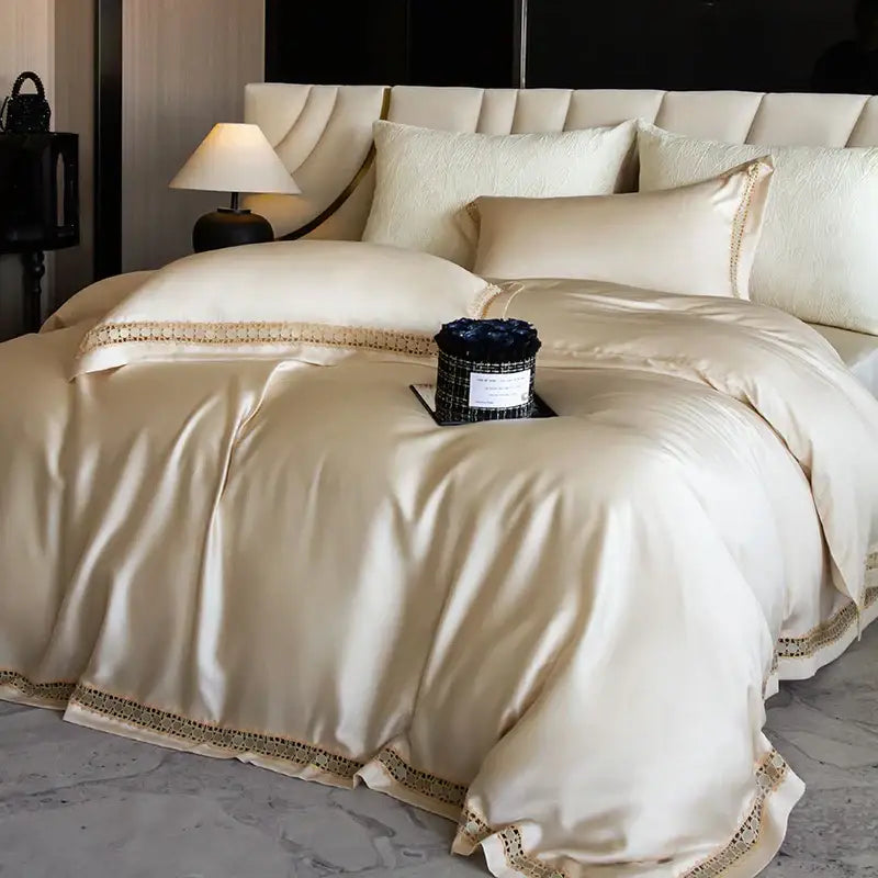 Cream-colored satin duvet cover set with gold-toned lace trim for elegant bedroom bedding use