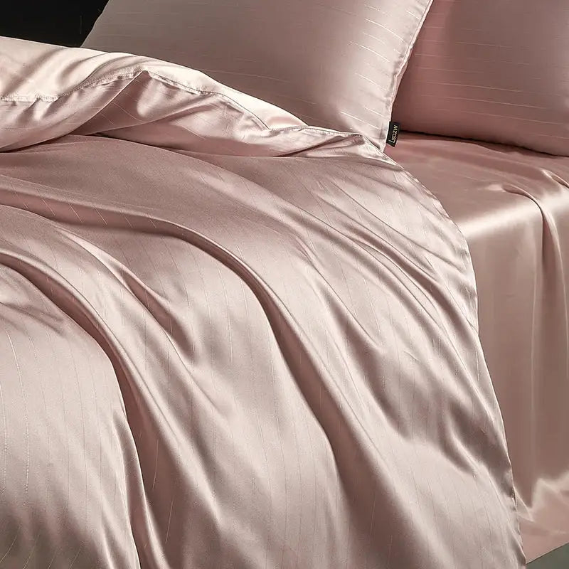 Pink satin duvet cover with subtle vertical stripes in bedding set featuring dark gray and silver pinstripe design